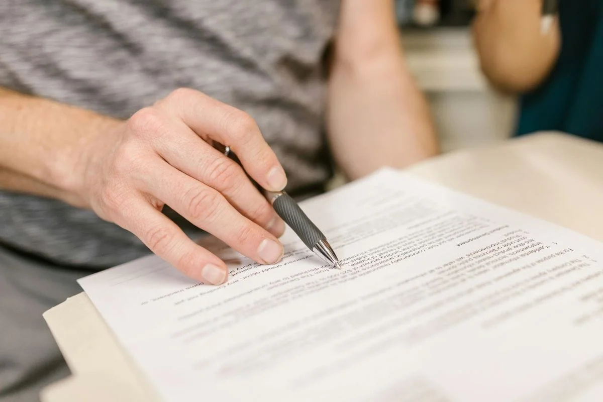 Person reviewing lease agreement when selling a tenanted rental property